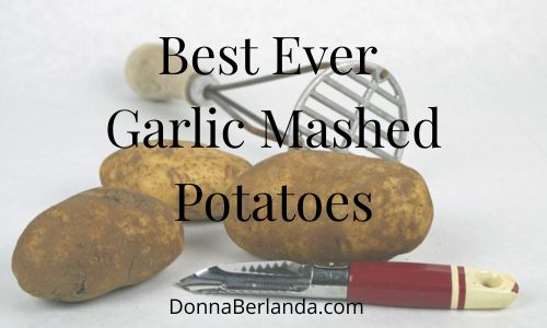 Potaotes, a vintage pototo masher and a vintage potato peeler with a red wooden handle.